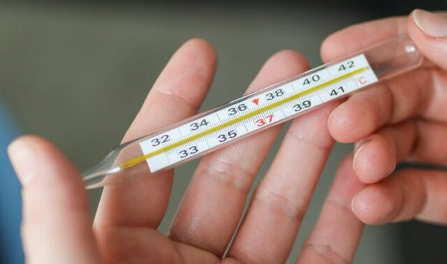 pexels-photo-3873175 person holding thermometer