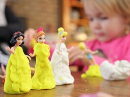 selective focus photography of three disney princesses figurines on brown surface