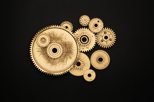pexels-photo-3785930 photo of golden cogwheel on black background